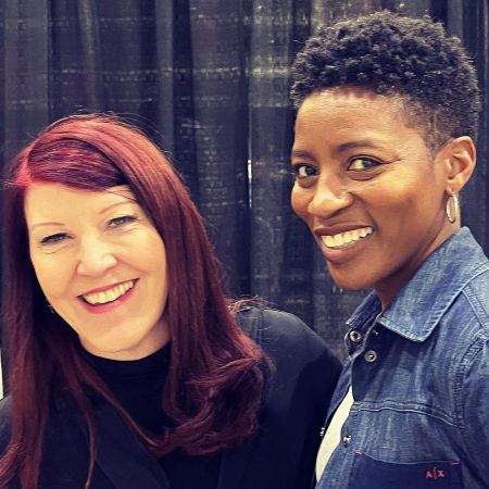 Ameenah Kaplan and Kate Flannery are smiling for the picture.